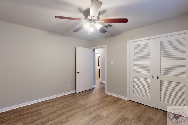 unfurnished bedroom with a closet, ceiling fan, and wood-type flooring