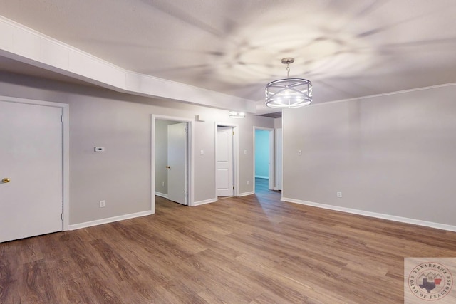 unfurnished room with hardwood / wood-style floors and ornamental molding