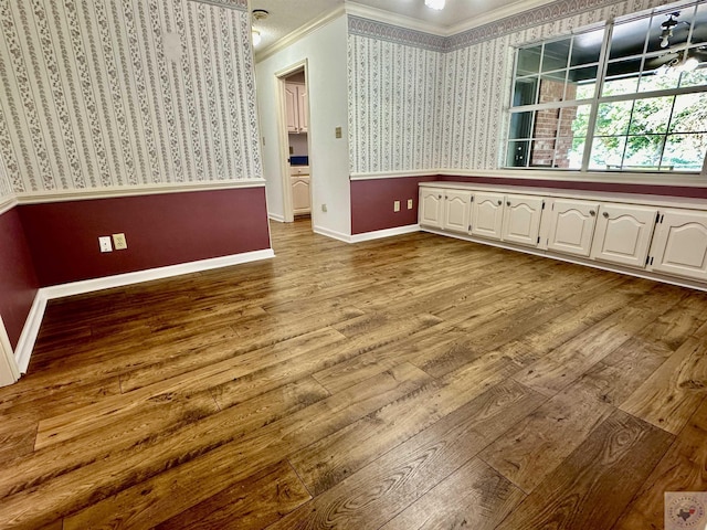 interior space with light hardwood / wood-style floors and ornamental molding