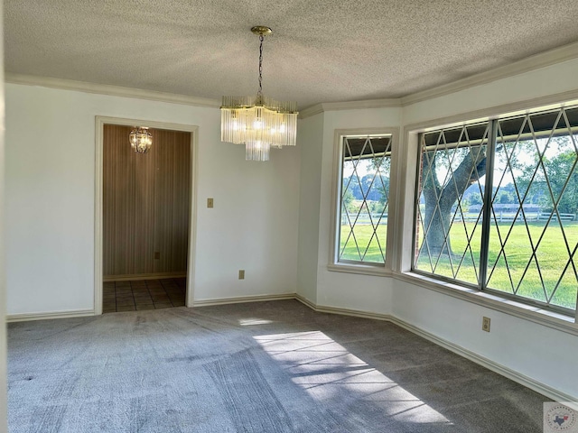 carpeted empty room with a chandelier, plenty of natural light, and a textured ceiling