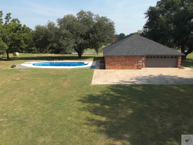 view of pool with a lawn