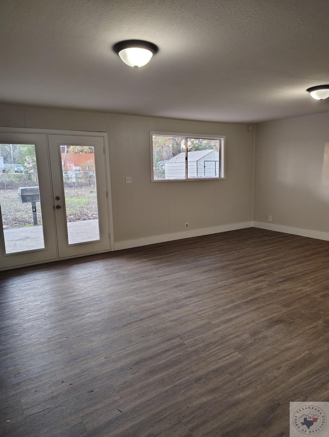 unfurnished room with french doors and dark wood-type flooring