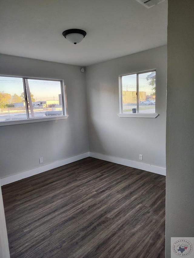 unfurnished room with dark hardwood / wood-style floors