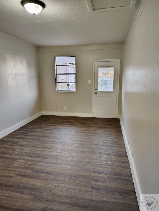 spare room featuring dark wood-type flooring