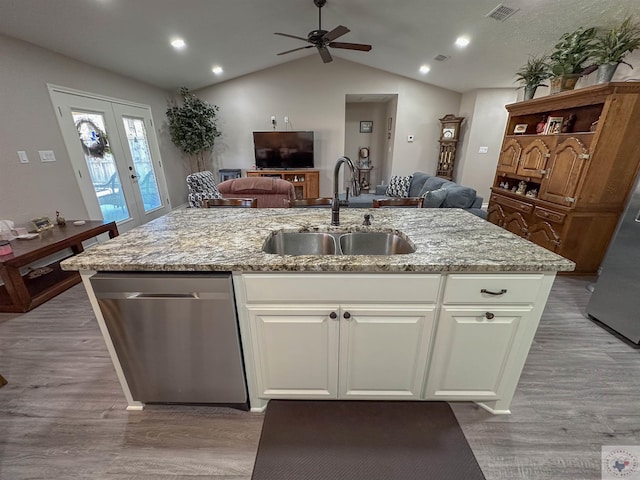 kitchen featuring a kitchen island with sink, sink, white cabinetry, and dishwasher