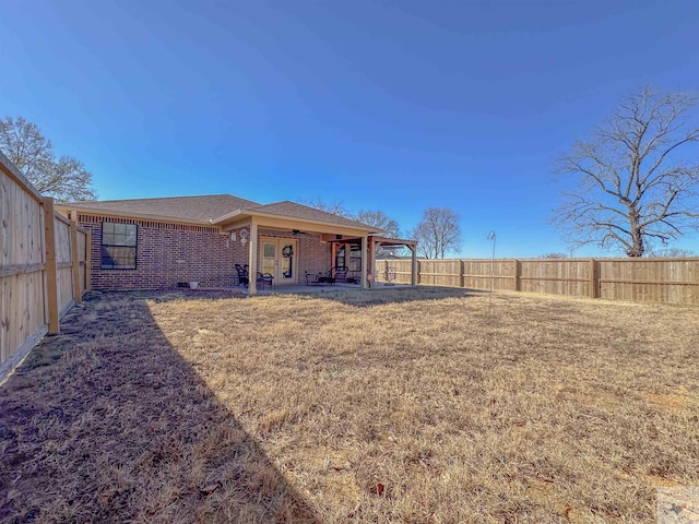 back of property with a patio area and a lawn