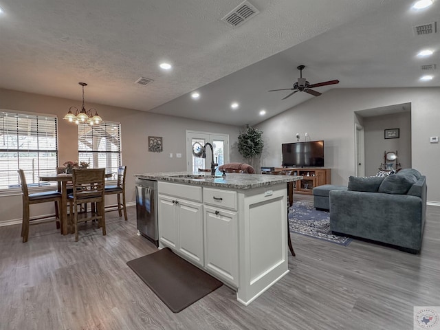 kitchen with sink, stainless steel dishwasher, an island with sink, pendant lighting, and white cabinets