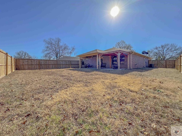 back of property featuring a yard