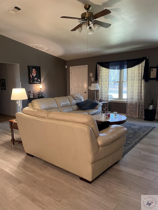 living room featuring light hardwood / wood-style floors and ceiling fan