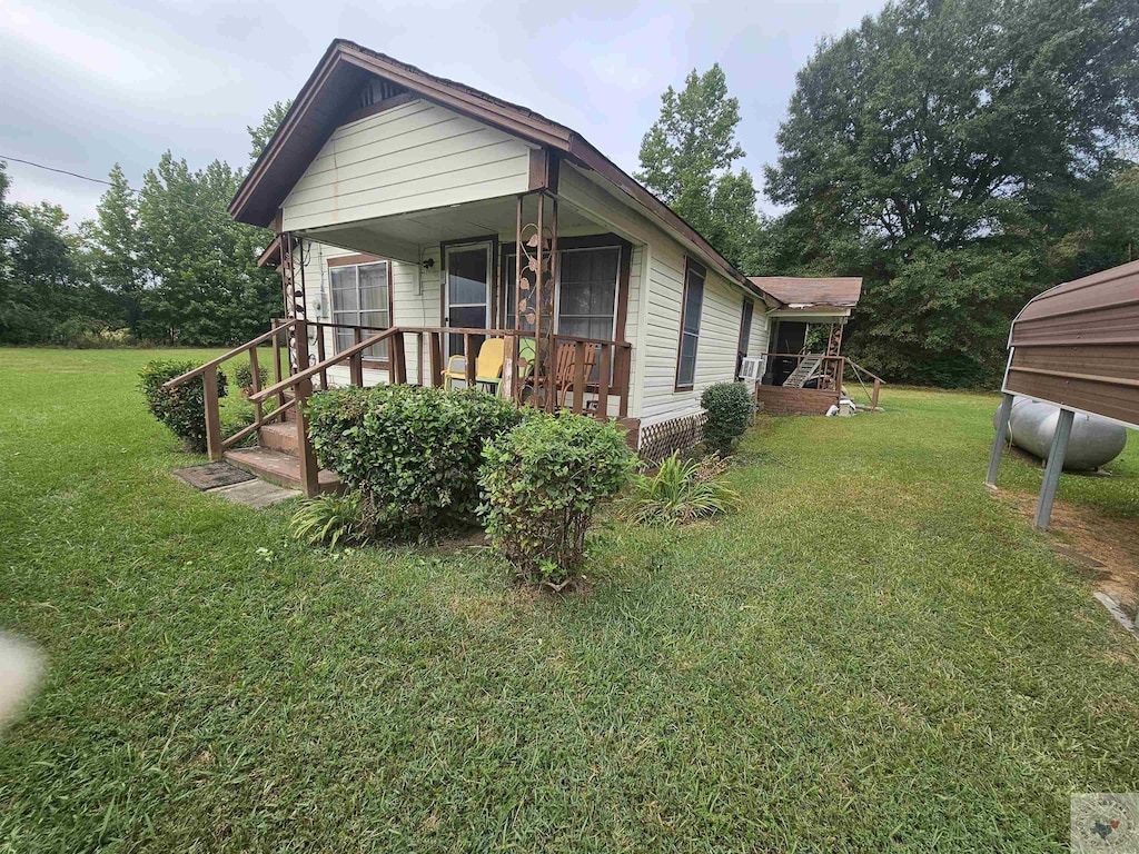 view of side of home with a lawn