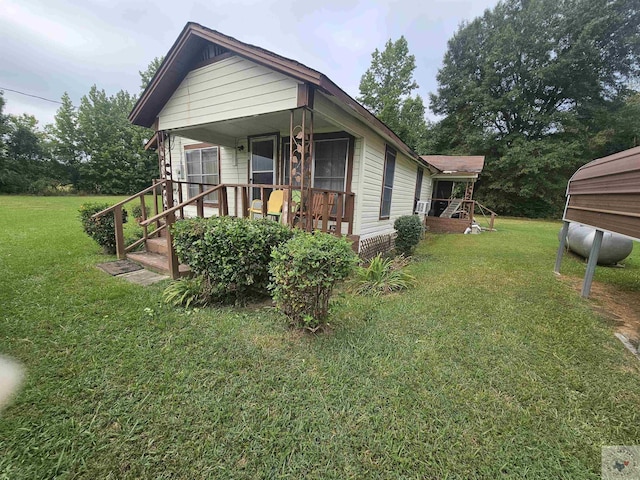 view of side of home with a lawn