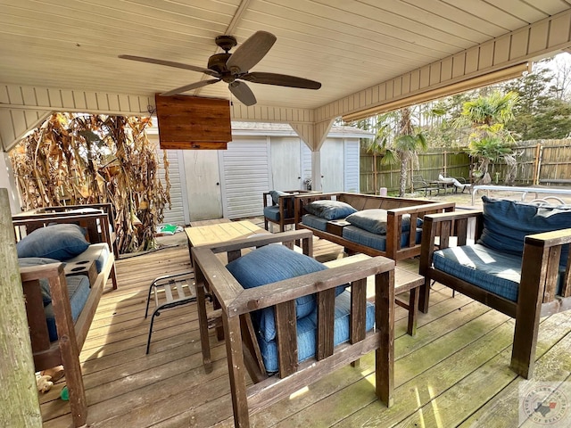 wooden deck featuring outdoor lounge area and ceiling fan