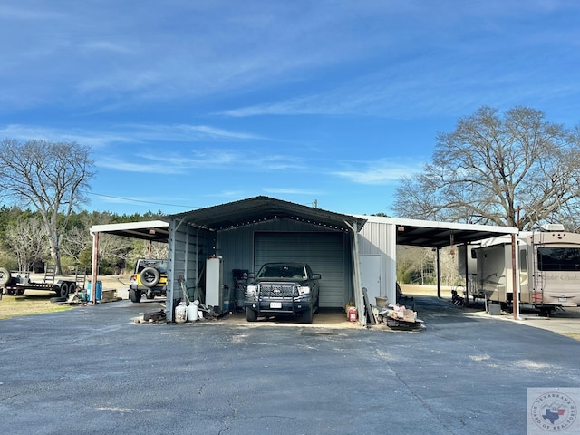 exterior space with a carport and a garage