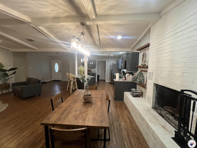 4801 Sanderson Ln, Texarkana, AR 71854 - dining area with dark wood-style flooring, beamed ceiling, and a brick fireplace