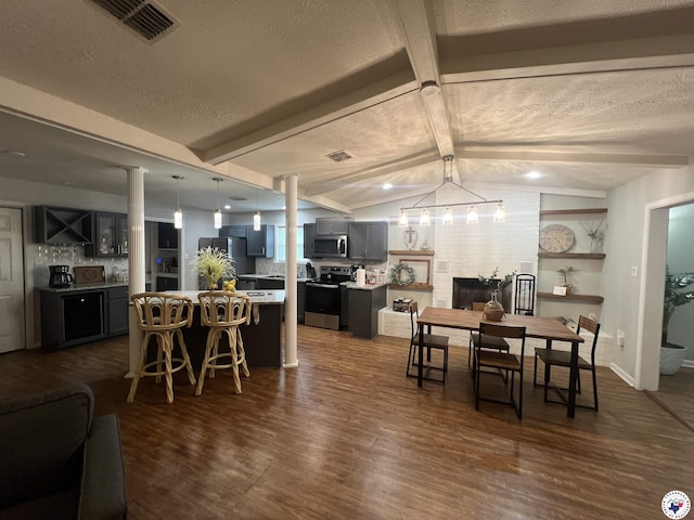 4801 Sanderson Ln, Texarkana, AR 71854 - dining space featuring dark wood-style floors, a textured ceiling, bar, and a chandelier