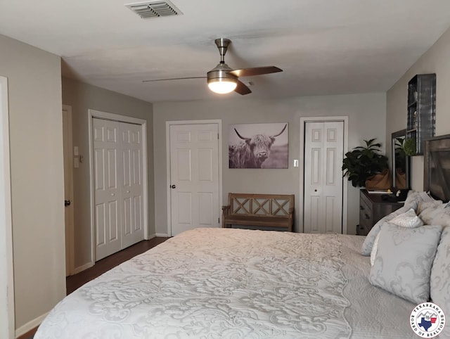 4801 Sanderson Ln, Texarkana, AR 71854 - bedroom with two closets, dark wood-type flooring, and ceiling fan
