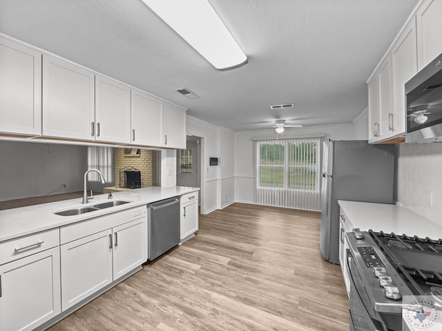 kitchen with sink, white cabinetry, ceiling fan, and appliances with stainless steel finishes