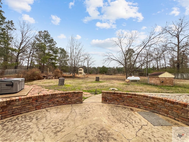 view of patio / terrace with a hot tub and a playground