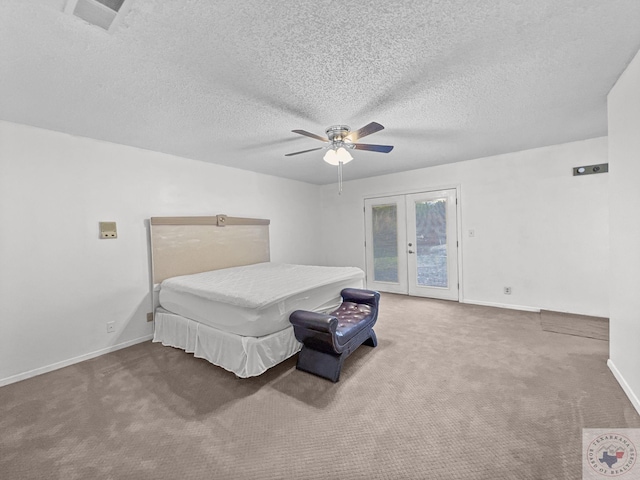 carpeted bedroom with ceiling fan, access to exterior, a textured ceiling, and french doors