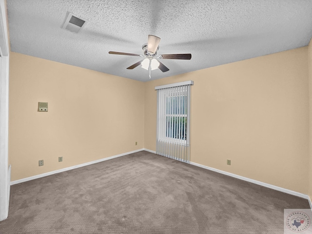 carpeted empty room with ceiling fan and a textured ceiling