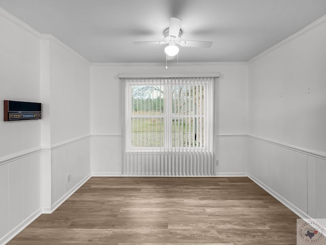 spare room with ceiling fan, hardwood / wood-style flooring, and crown molding