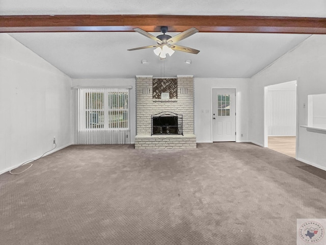 unfurnished living room with a brick fireplace, carpet, lofted ceiling with beams, and ceiling fan