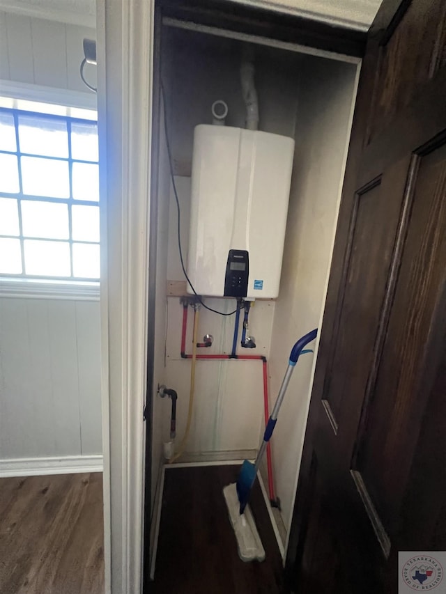 utility room featuring tankless water heater