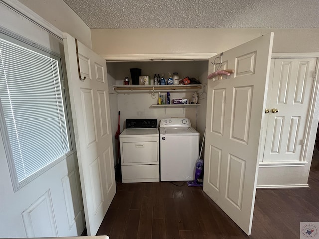 washroom featuring dark wood-style floors, laundry area, a textured ceiling, and separate washer and dryer