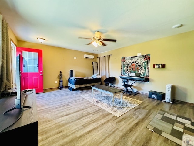 living room with ceiling fan, wood-type flooring, and a wall mounted AC