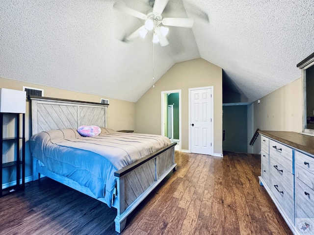 bedroom with ceiling fan, a textured ceiling, dark hardwood / wood-style floors, and vaulted ceiling