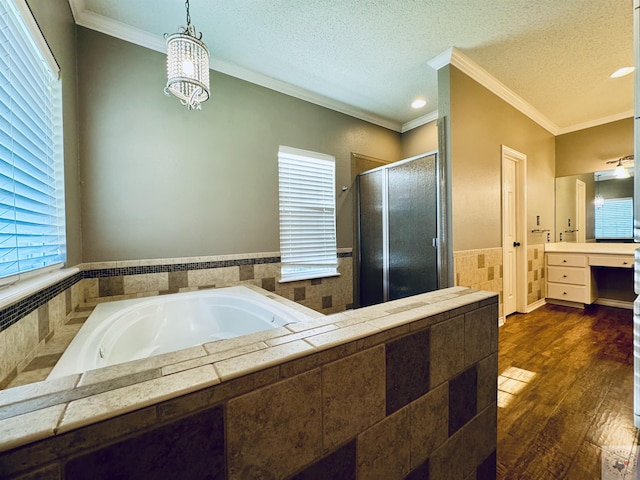 bathroom with vanity, crown molding, a textured ceiling, and hardwood / wood-style floors