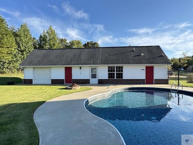 view of pool with a patio area and a lawn