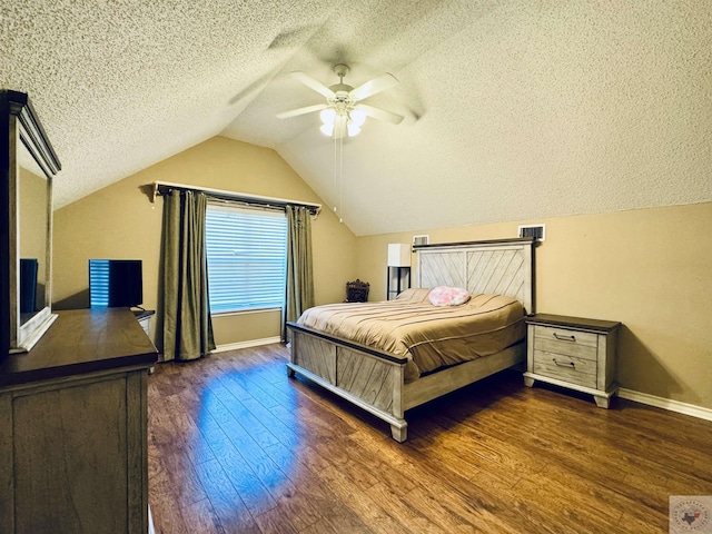 bedroom with ceiling fan, a textured ceiling, dark hardwood / wood-style floors, and vaulted ceiling