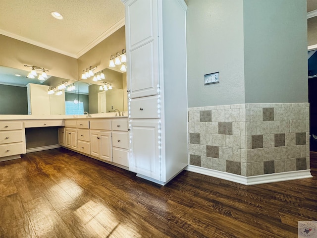 bathroom featuring vanity, ornamental molding, a textured ceiling, and hardwood / wood-style floors