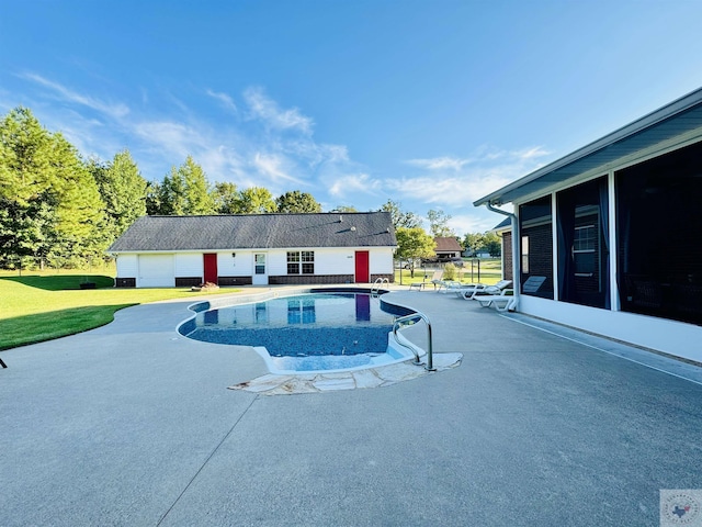 view of pool with a sunroom, a lawn, and a patio