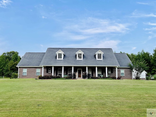 cape cod home with a front lawn