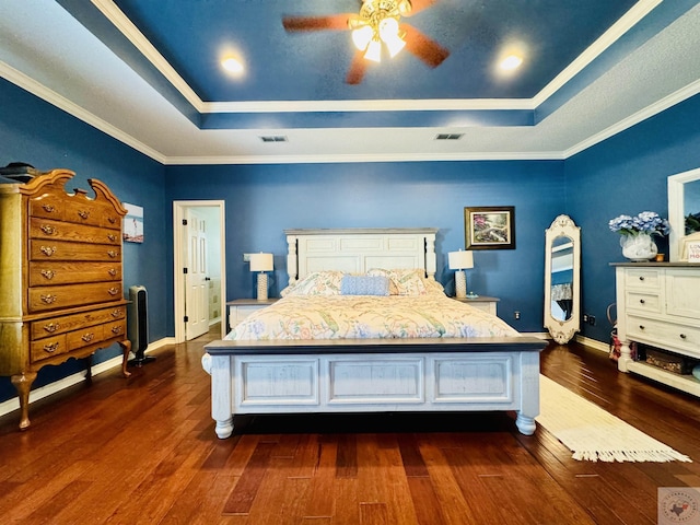 bedroom with ceiling fan, crown molding, dark hardwood / wood-style flooring, and a raised ceiling