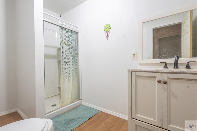 9411 S Fm 137, Paris, TX 75418 - full bath with baseboards, toilet, a stall shower, wood finished floors, and vanity