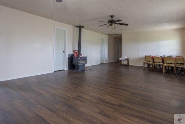 9411 S Fm 137, Paris, TX 75418 - interior space with dark wood finished floors, a wood stove, and ceiling fan