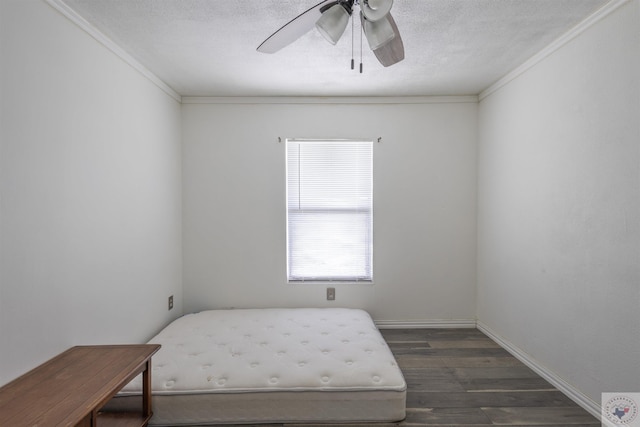 9411 S Fm 137, Paris, TX 75418 - bedroom featuring dark wood-type flooring, a textured ceiling, crown molding, baseboards, and ceiling fan