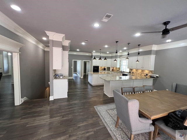 dining area featuring ceiling fan, dark hardwood / wood-style flooring, and ornamental molding