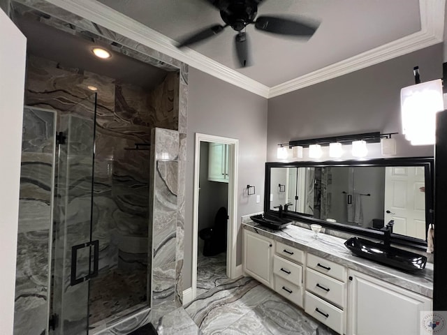 bathroom with ceiling fan, a shower with door, crown molding, and vanity