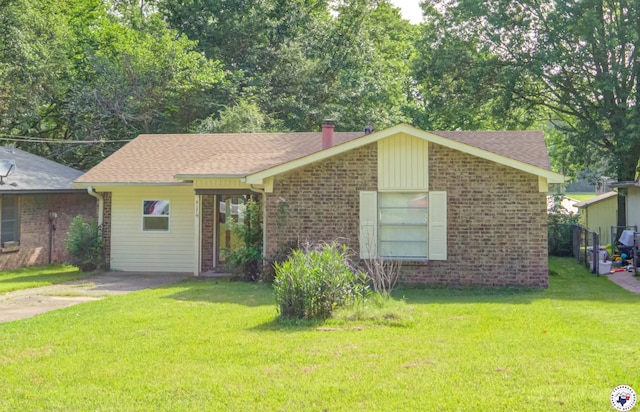 417 Carroll Ave, Wake Village, TX 75501 - view of front of home with brick siding, a front yard, and a shingled roof