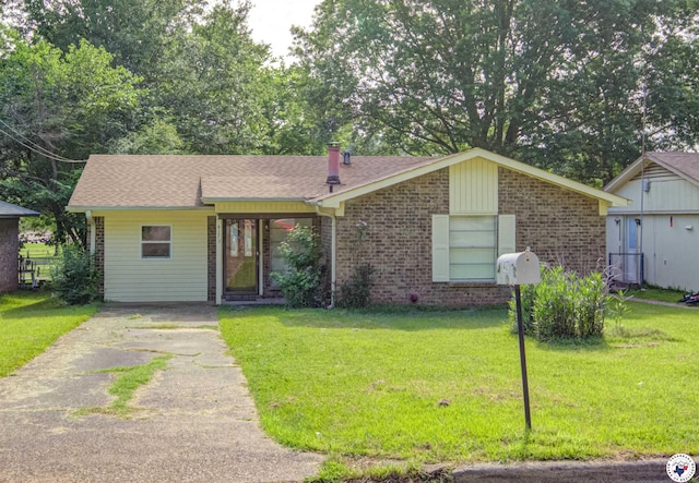 417 Carroll Ave, Wake Village, TX 75501 - ranch-style house featuring a front yard, brick siding, concrete driveway, and roof with shingles