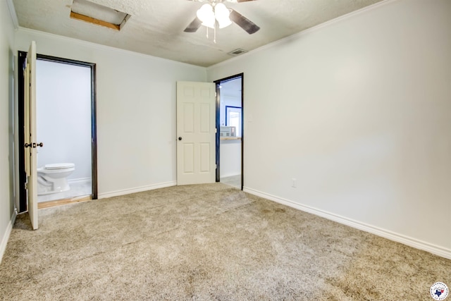 417 Carroll Ave, Wake Village, TX 75501 - unfurnished bedroom featuring attic access, carpet flooring, ornamental molding, ensuite bathroom, and a ceiling fan
