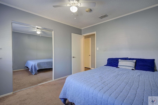 bedroom with a closet, visible vents, carpet, and ornamental molding