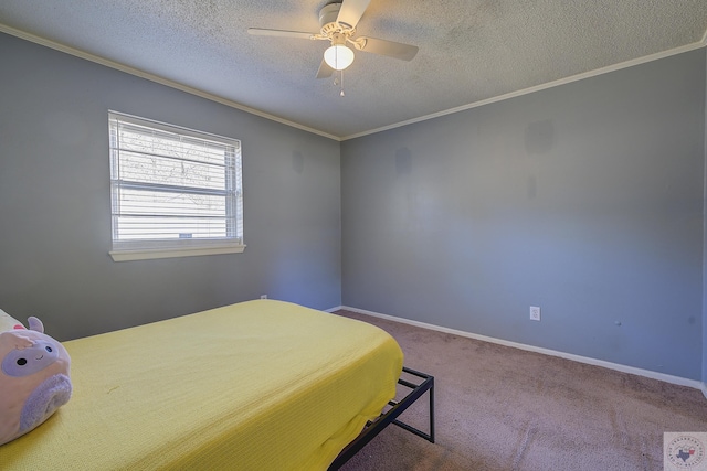 carpeted bedroom with baseboards, a textured ceiling, and crown molding