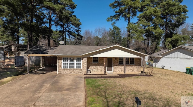 ranch-style house with a front lawn, a carport, fence, and driveway