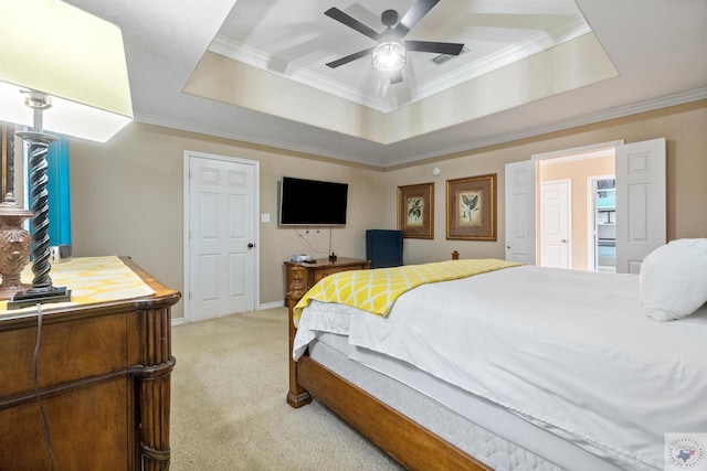 bedroom with ceiling fan, a raised ceiling, light colored carpet, and crown molding