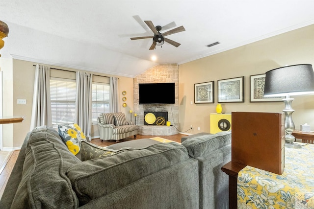 living room featuring vaulted ceiling, a stone fireplace, and ceiling fan